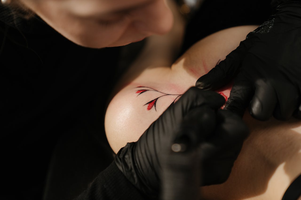 Crafting Captivating Headlines: Your awesome post title goes here Close-up of a tattoo artist working on a floral design in a studio.